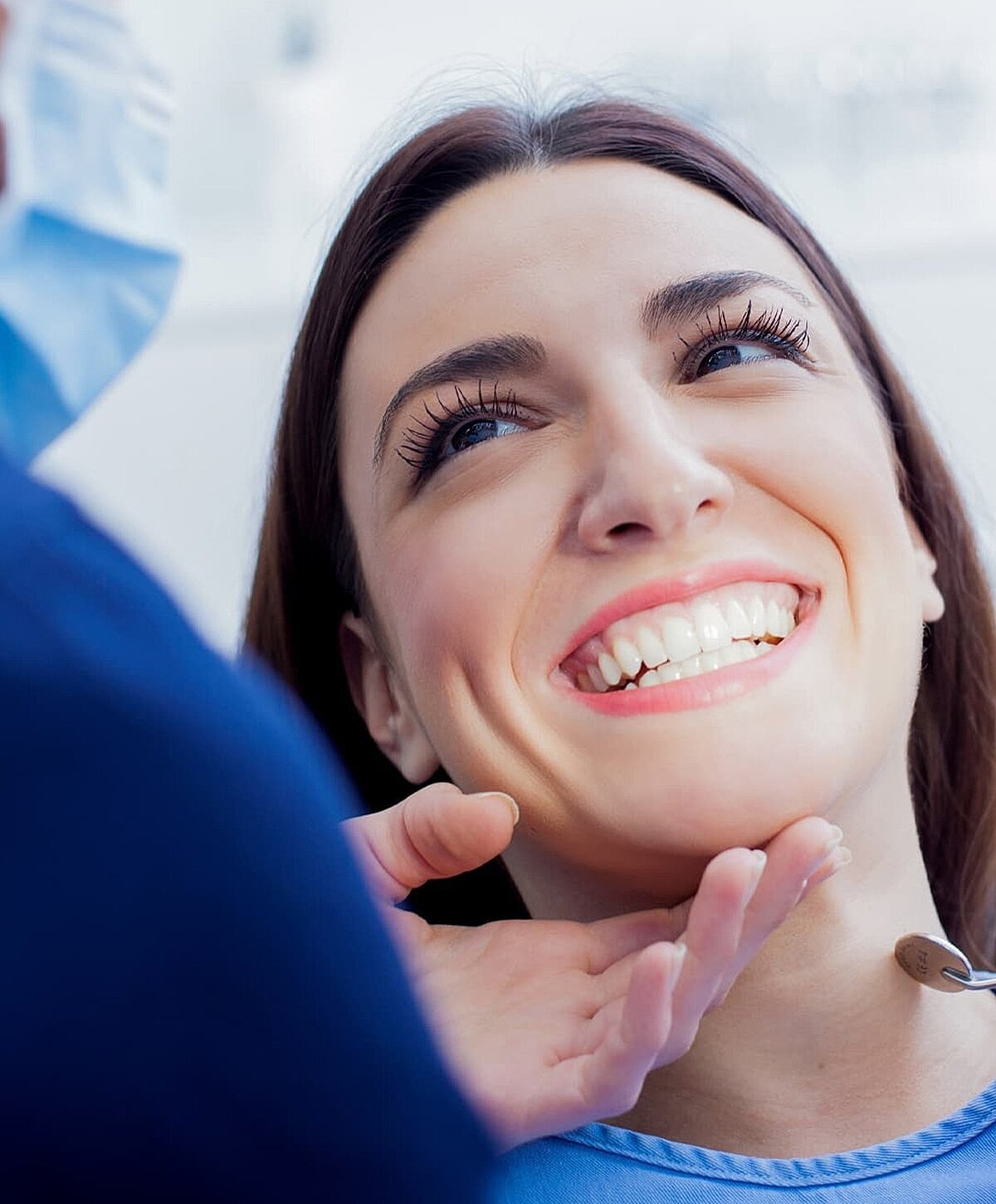 Patient smiling during dental check-up.