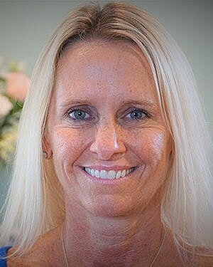 Smiling woman with long, blonde hair.