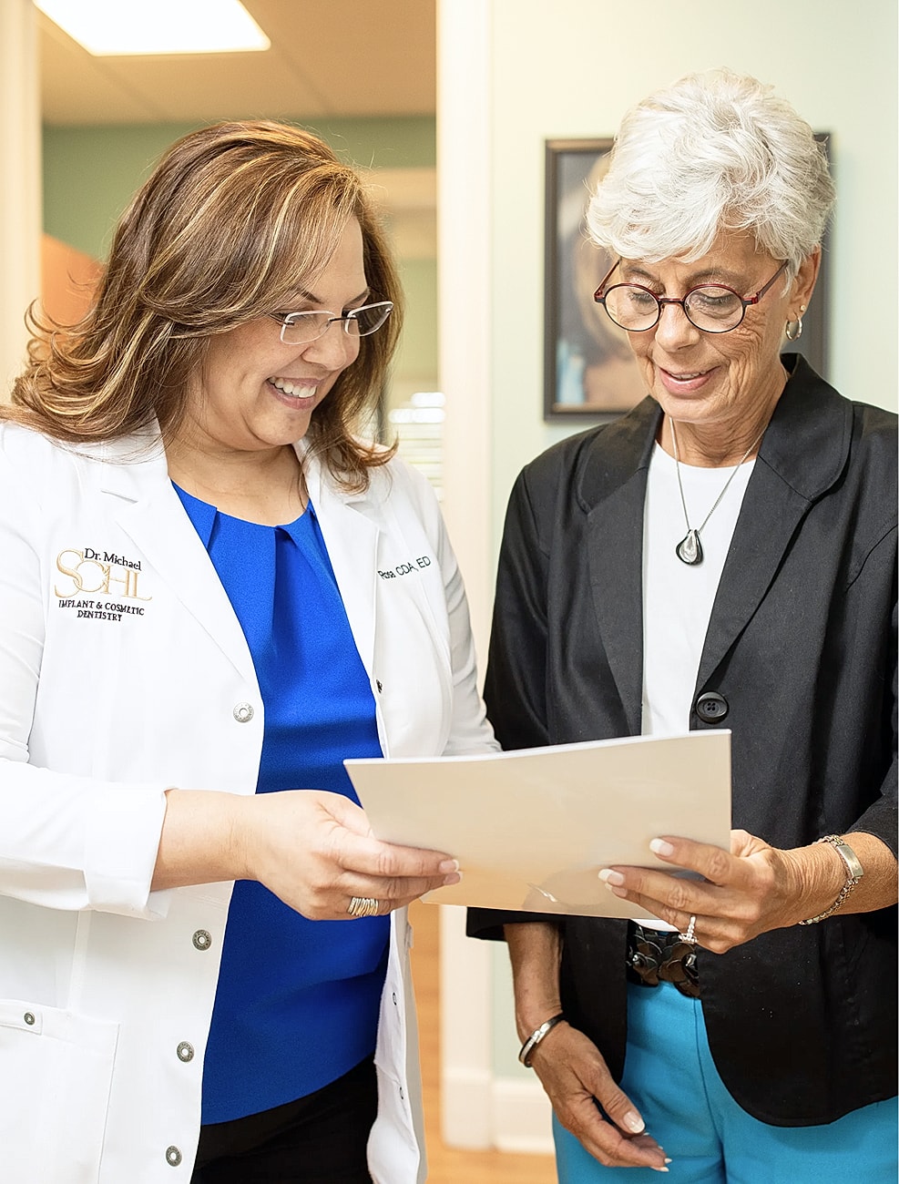 Dentist consulting with patient about treatment plan.