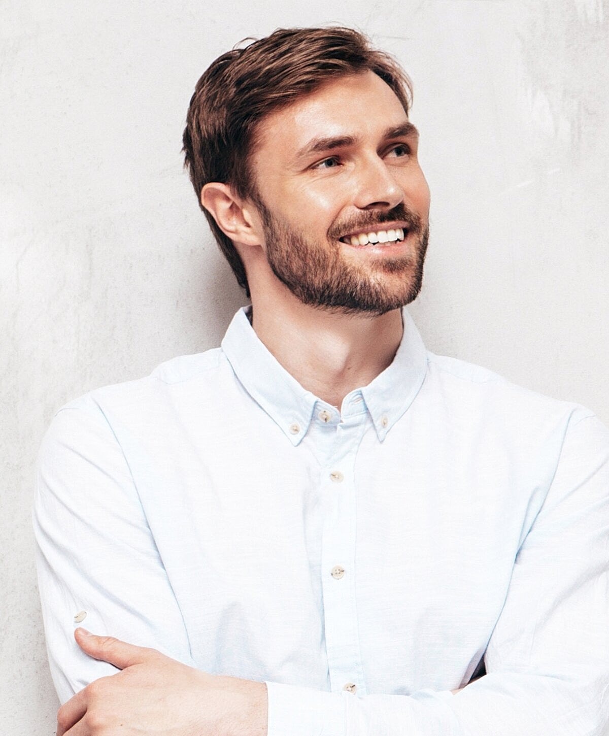 Smiling doctor in a dental office setting.