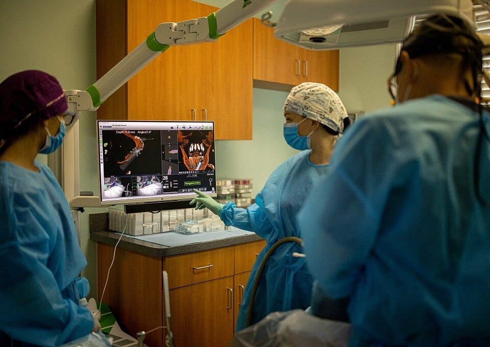 Dental professionals collaborating with advanced technology.