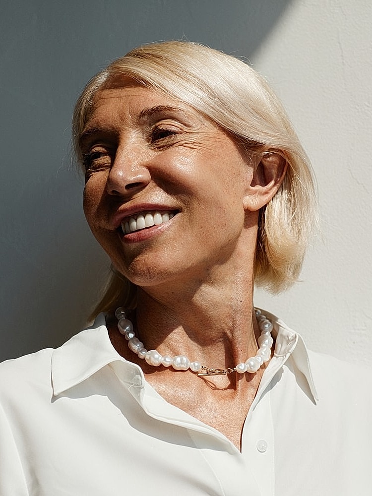 Smiling doctor in a dental office setting.