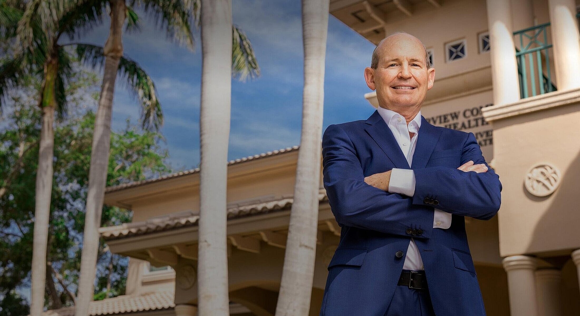 Business professional standing outside modern building.