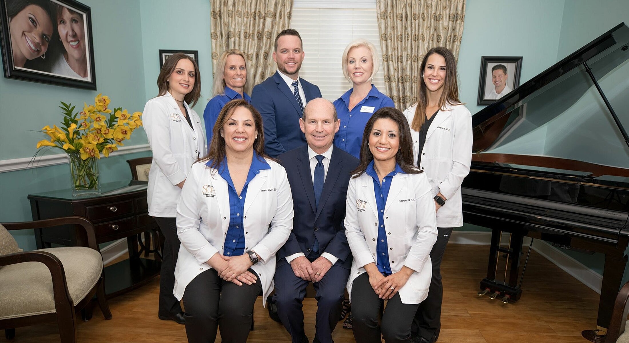 Dental team posing in office setting.