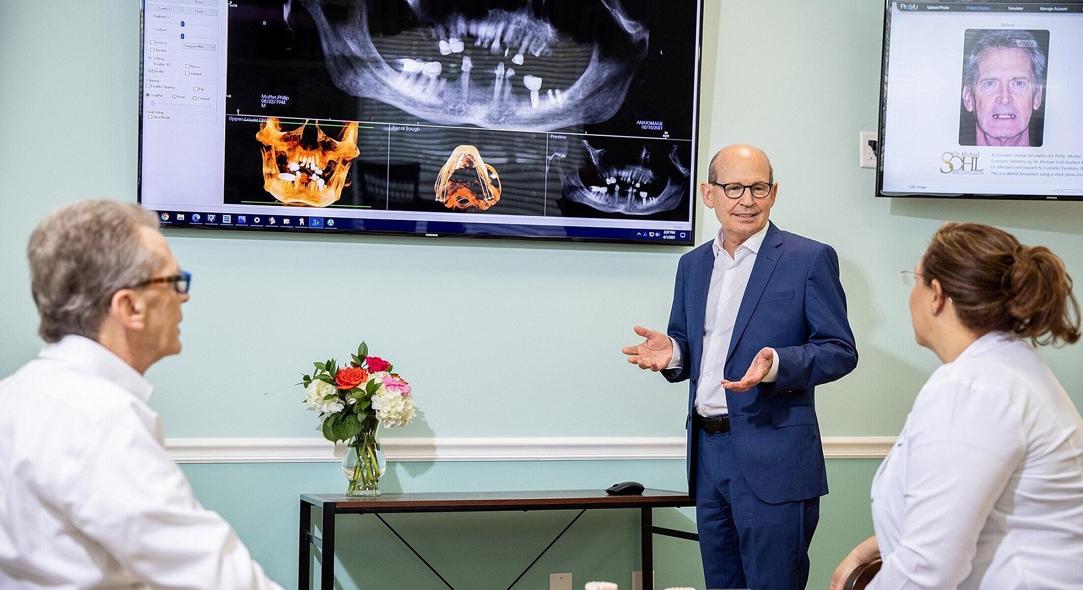 Dental consultation with digital imaging demonstration.