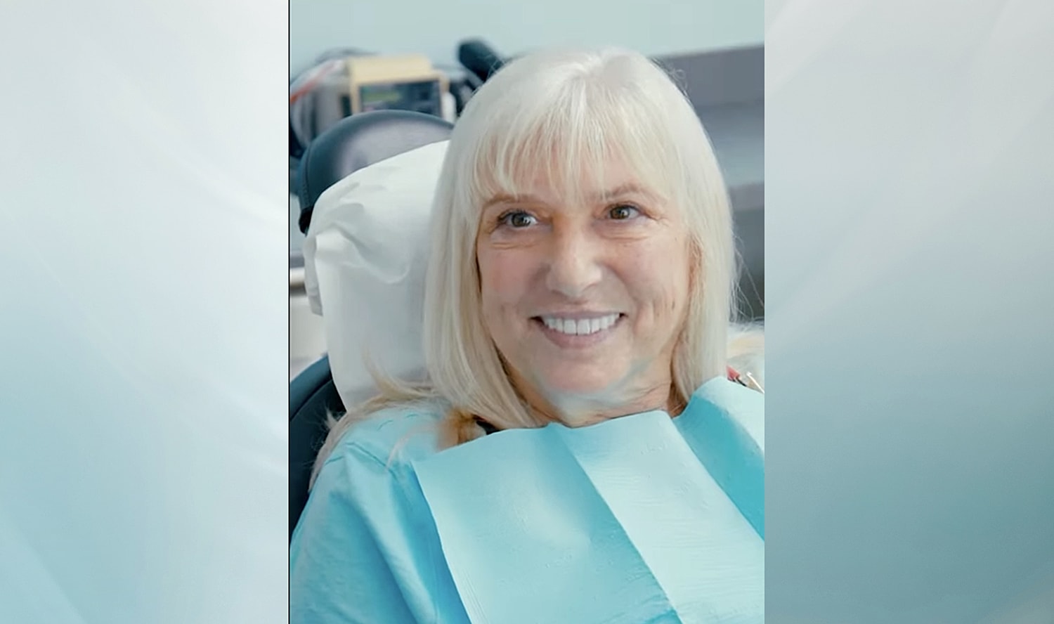 Man in a cowboy hat smiling warmly indoors.