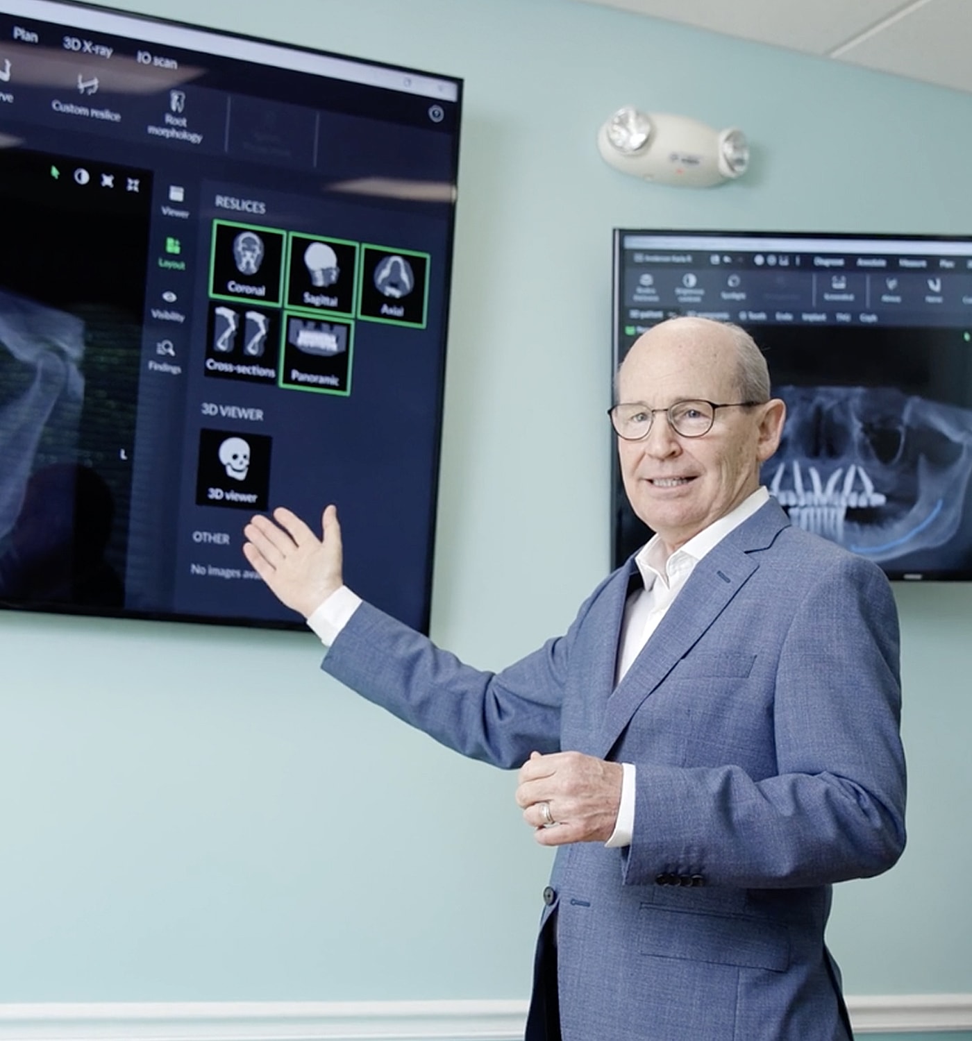 Man presenting dental imaging technology in office.